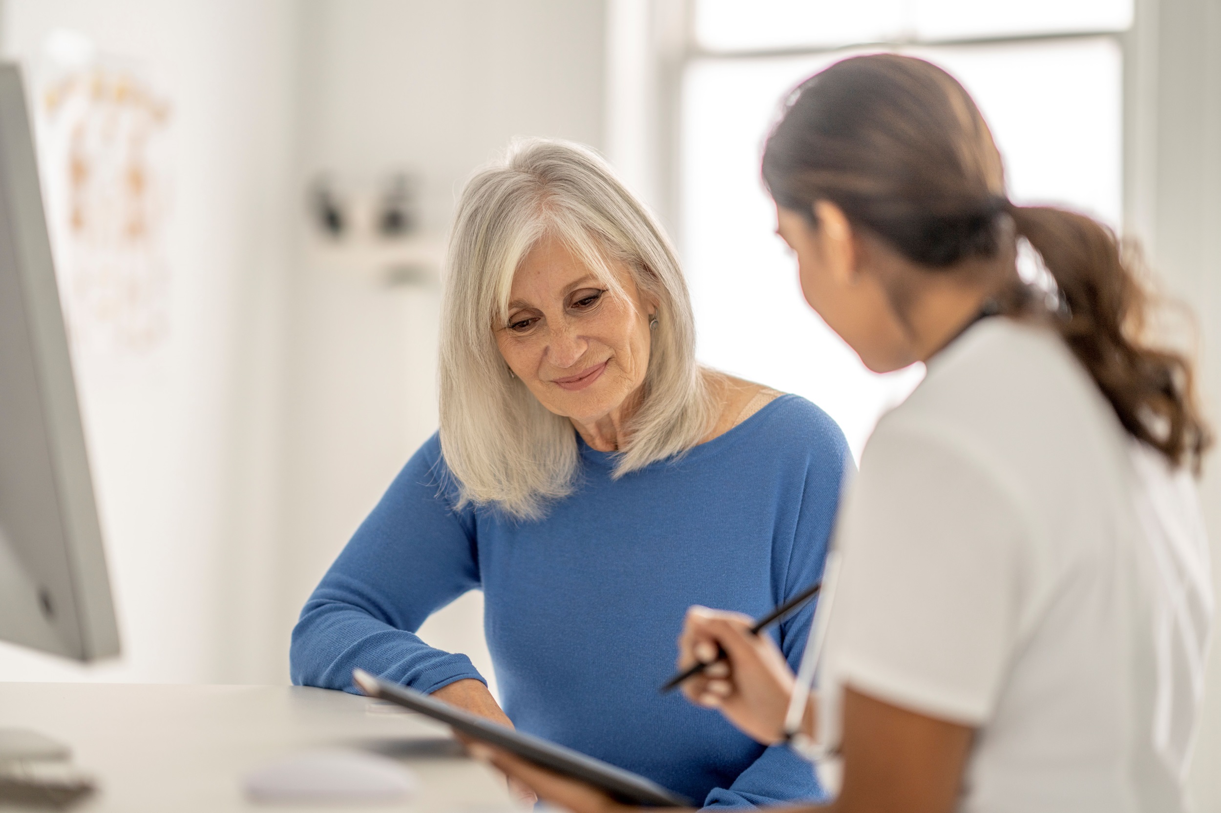 Doctor explaining to elderly patient