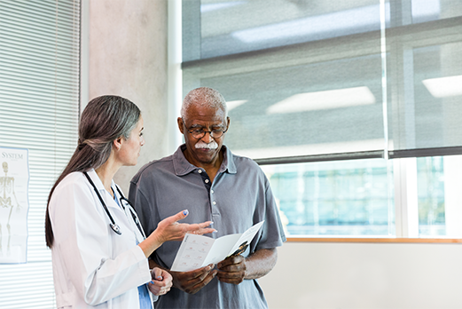 1643-2HealthAndWellness-521x348 Doctor reviewing information with patient