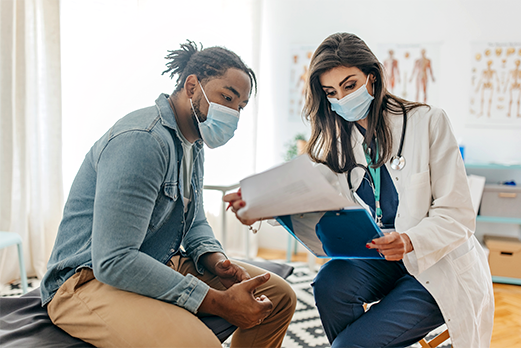 1643-8HealthAndWellness-521x348 Doctor reviewing information with patient
